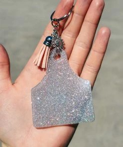 The Cinchy Cowgirl Holographic Silver Ear Tag Keychain