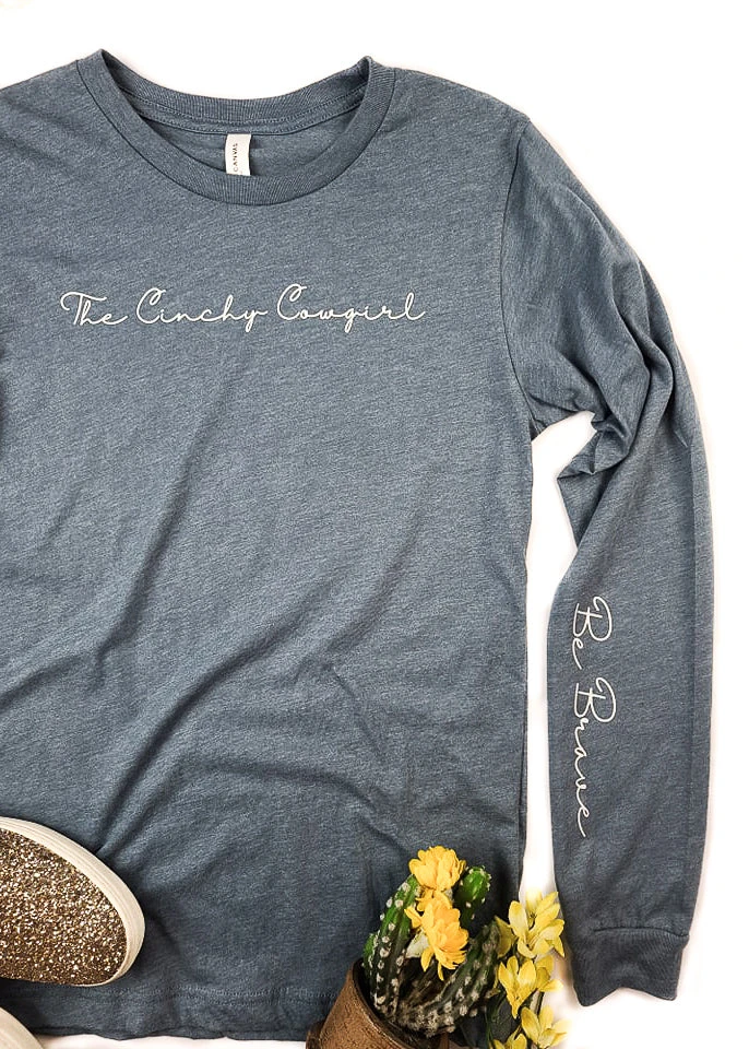 Be Brave Cinchy Cowgirl Heather Slate Long Sleeve Graphic Tee | TCC Graphic Tanks & Tees 3 The Cinchy Cowgirl Heather Slate Be Brave Long Sleeve Graphic Tee