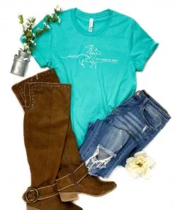 The Cinchy Cowgirl Clothing Teal She Cannot Be Tamed Short Sleeve Graphic Tee